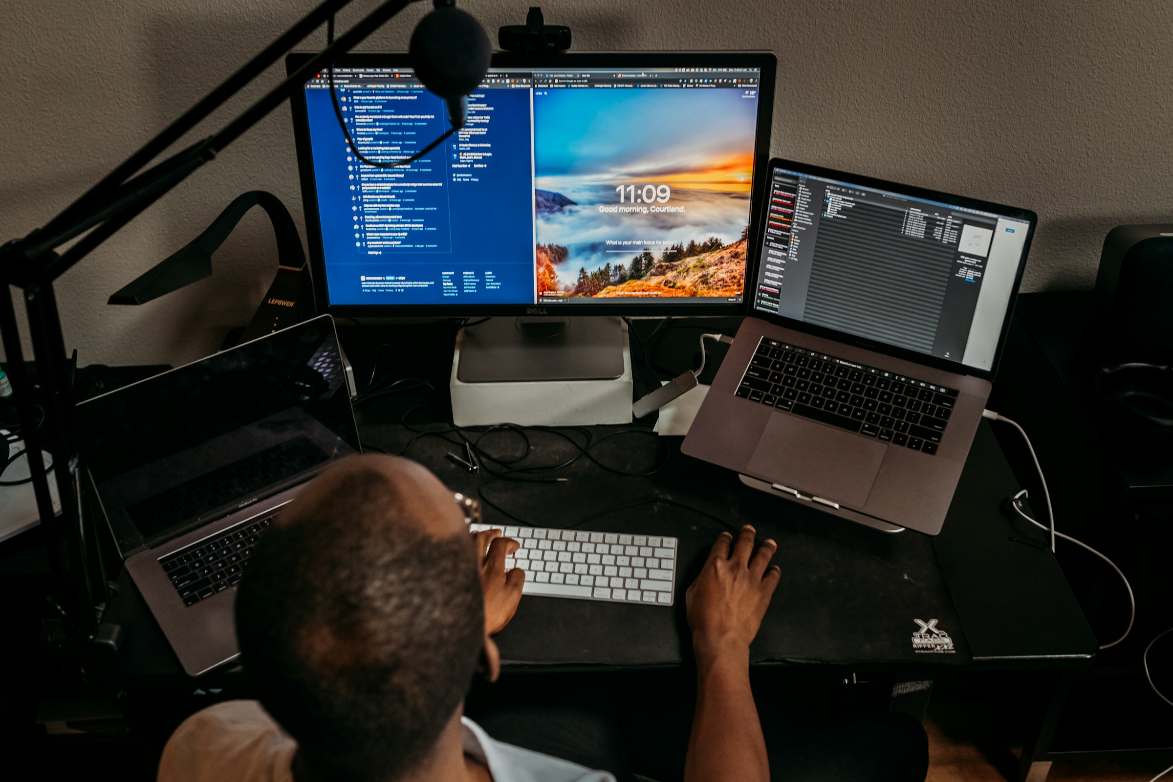 Adult working at a digital workstation, viewed from behind