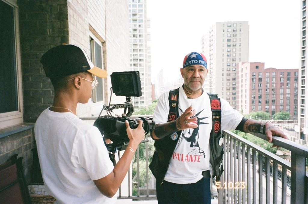 Chino Familia sharing his story on a balcony during filming of West Side Familia.