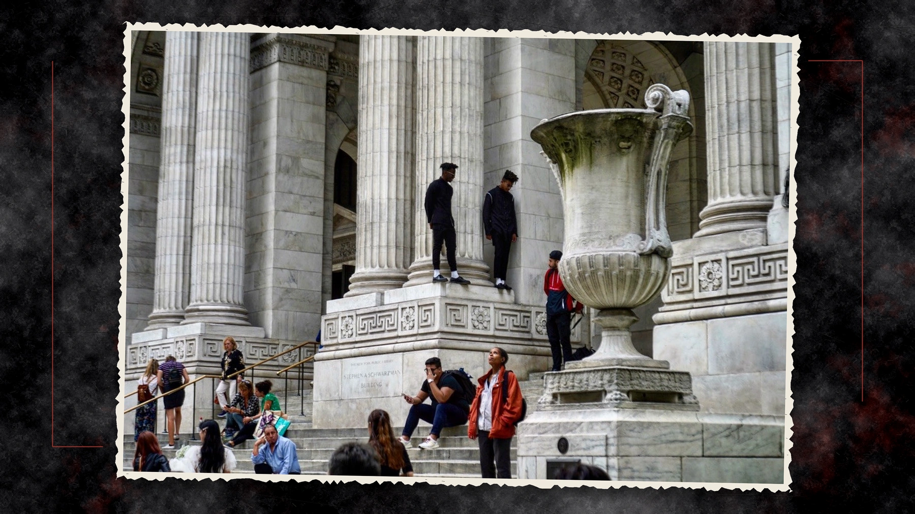 People gathered on the steps of the New York Public Library, photographed by César Vargas, framed as a torn-paper clipping against a textured charcoal and red background.