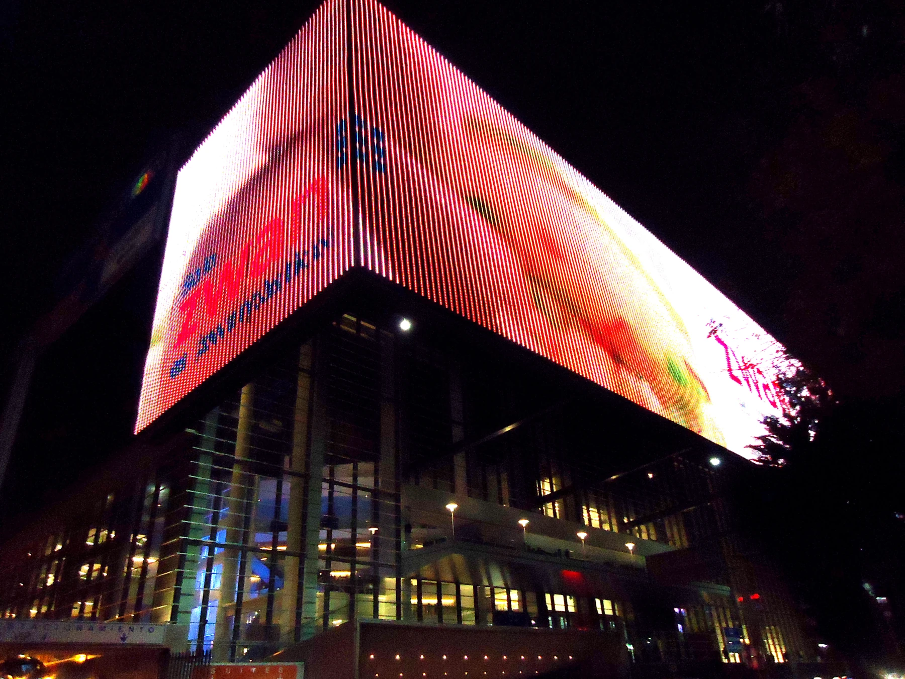 Arena Ciudad de México's illuminated exterior in an archival night photograph.