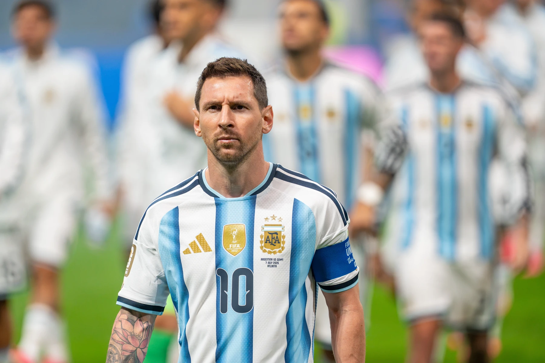 Lionel Messi in Argentina's number 10 shirt and captain's armband, with teammates behind him.