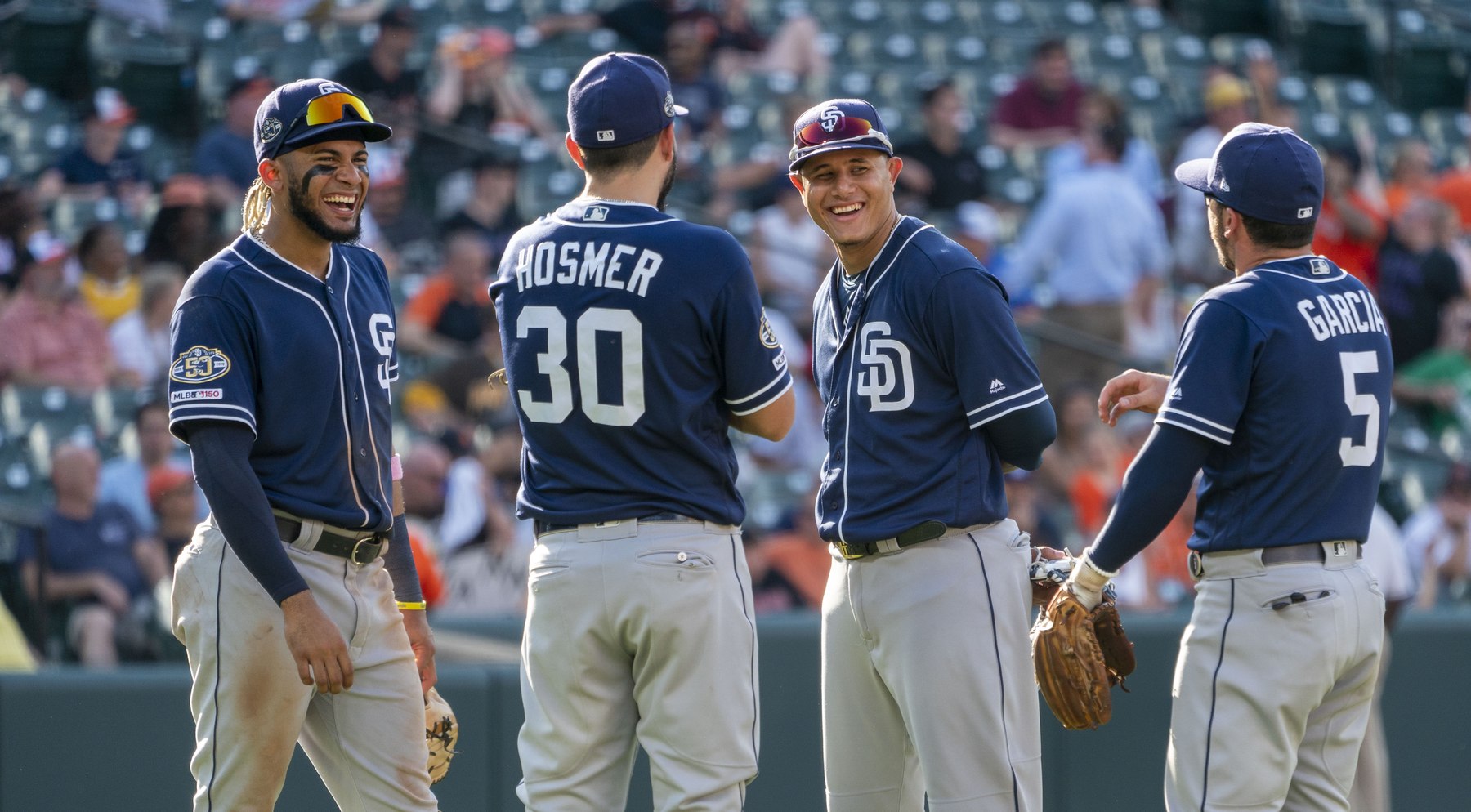 Fernando Tatis Jr. and Manny Machado standing together in San Diego Padres uniforms in Baltimore in 2019.